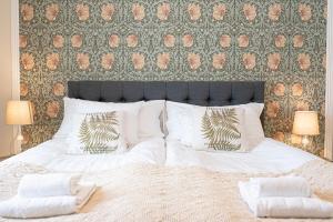 a bedroom with a large bed with white sheets and pillows at Tokeryds Herrgård in Jönköping