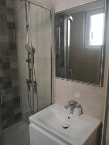 a bathroom with a sink and a shower with a mirror at Old Town in Pula