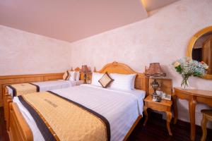 Postel nebo postele na pokoji v ubytování Duc Vuong Saigon Hotel - Bui Vien