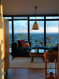 a living room with a couch and a table at lodge-bélvédere sur les hauteurs de vichy in Vichy