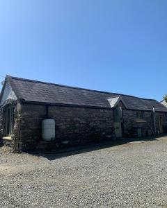 an old brick building with a door on it at Ancaire Studio in Schull