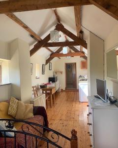 a living room with a couch and a kitchen at Ancaire Studio in Schull