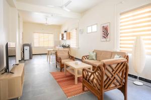 a living room with a couch and a table at Neemtree Apartments in Hyderabad