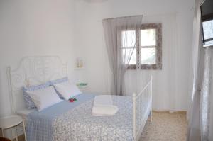 a bedroom with a bed and a window at Aristea Apartment in Milatos