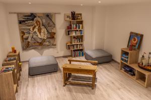 a living room filled with furniture and a book shelf at Villa 18 in Porto-Vecchio