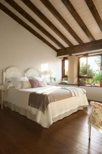 a bedroom with a large bed in a room with windows at LA POSADA in Silió