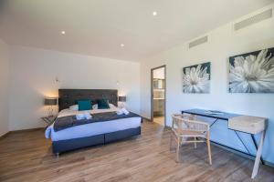 a bedroom with a bed and a desk in it at Villa 18 in Porto-Vecchio +17 photos
