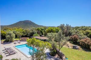 a pool in a yard with a mountain in the background at Villa 18 in Porto-Vecchio