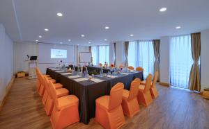 a conference room with a long table and orange chairs at Aabas Pokhara by Barahi Hospitality in Pokhara