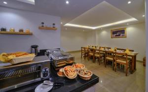 a restaurant with a counter with baskets of bread and a table at Aabas Pokhara by Barahi Hospitality in Pokhara