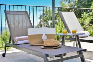 a picnic table with a hat and two glasses of orange juice at Terre d'Orizon in Tourrettes-sur-Loup