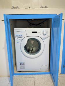 a washer and dryer in a blue box at Casa Vacanze Casti - 41 in Calasetta