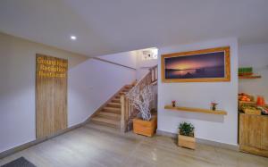 a room with a staircase and a sign on the wall at Aabas Pokhara by Barahi Hospitality in Pokhara