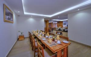 a dining room with a long table and chairs at Aabas Pokhara by Barahi Hospitality in Pokhara
