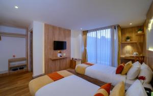 a hotel room with two beds and a window at Aabas Pokhara by Barahi Hospitality in Pokhara