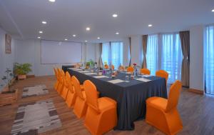 a conference room with a long table and orange chairs at Aabas Pokhara by Barahi Hospitality in Pokhara
