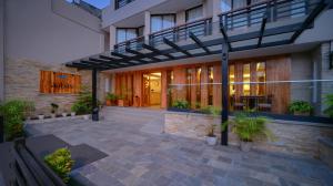 a building with a patio with potted plants at Aabas Pokhara by Barahi Hospitality in Pokhara