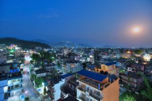 a view of a city at night at Aabas Pokhara by Barahi Hospitality in Pokhara