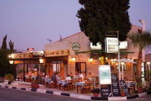 a restaurant with people sitting at tables in front of it at Villa Kassiopeia by Villa Plus in Peyia