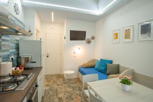 a kitchen and a living room with a couch in a room at EDEN CONERO Appartamento IL PORTO - NUMANA CENTRO in Numana