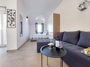 a living room with a couch and a table with wine glasses at Apartments Lavanda - free parking and grill in Jezera