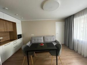ein Wohnzimmer mit Sofa und Tisch in der Unterkunft Harmonija in Ludza