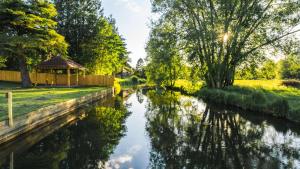 a river with a gazebo next to it at The Riverside, WorldHotels Distinctive in Salisbury
