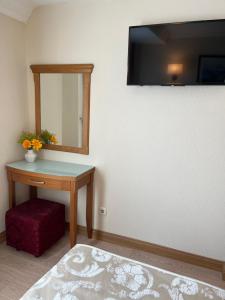 a room with a table and a mirror and a stool at Yavuz Hotel in Istanbul