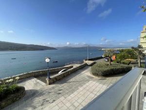 a view of a large body of water from a balcony at Grupo Gontad Casa Baixo da Capilla Corme in A Coruña