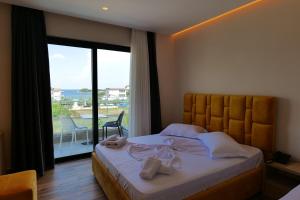 a bedroom with a bed with a view of the ocean at Hotel Alexander in Ksamil +37 photos