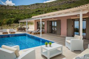 a villa with a swimming pool and a patio at Saint Nicholas Villas 3 in Skala