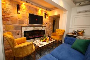 a living room with a blue couch and a fireplace at REN PLUS SUITES in Istanbul