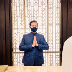 a man in a suit with a mask at Palasa Hotel in Muzaffarnagar