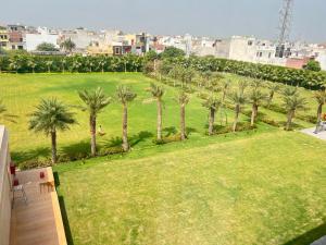 an aerial view of a park with palm trees at Palasa Hotel in Muzaffarnagar