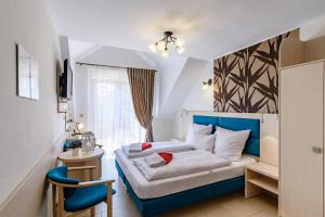 Postel nebo postele na pokoji v ubytování Paula Wellness & SPA