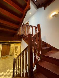 a wooden staircase in a house with wooden ceilings at Apartamento del s XVI en el casco histórico de Luanco in Luanco