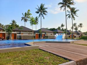 a pool at a resort with a water slide at The Allure Villas Managed by Sahid in Pangandaran