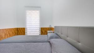 a bedroom with two beds and a window at VALLES DE ORTEGA 6 in Valles de Ortega