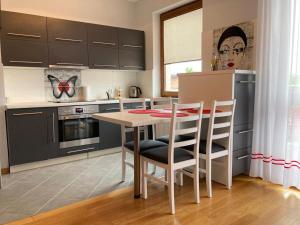 a kitchen with a table and chairs in a room at Apartament Centrum in Iława