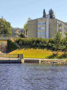 a bridge over the water in front of a building at Studio at Koulukatu in Savonlinna