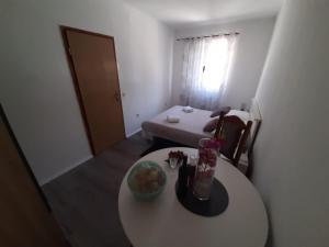 a room with a table with a bowl of fruit on it at Apartman Jadranka in Rogotin