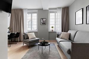 a living room with a couch and a table at Forenom Apartments Stockholm Johannesgatan in Stockholm