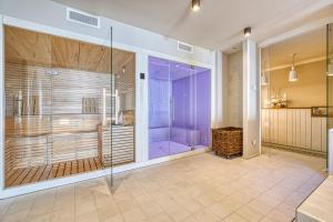 a large bathroom with a shower and a walk in shower at Madrigale Panoramic&Lifestyle Hotel in Costermano