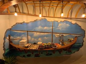 a painting of a boat on the wall at Old Town Inn Maldives in Gaafaru