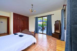 a bedroom with a bed and a sliding glass door at Villa Yiolani by Villa Plus in Lachi +19 photos