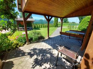 a porch with a bench and a gazebo at Domek Stary Bar in Piecki