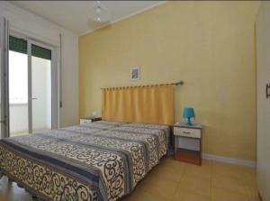 a bedroom with a large bed and a window at Gallipoli Mancaversa Futura Vacanza Andrea in Marina di Mancaversa