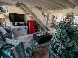 a living room with a couch and a tv at Marina La Vie in Jeffreys Bay