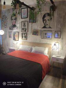 a bedroom with a bed with pictures on the wall at Itsara Suites in Le Touquet-Paris-Plage