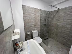 uma casa de banho com um chuveiro, um WC e uma banheira em VAMA BLUE em Vama Veche